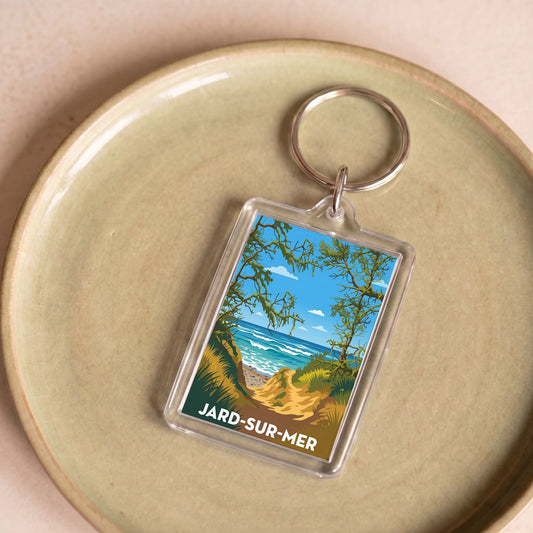 Porte-clés souvenir de la ville de Jard-sur-Mer avec une illustration stylisée de son littoral.