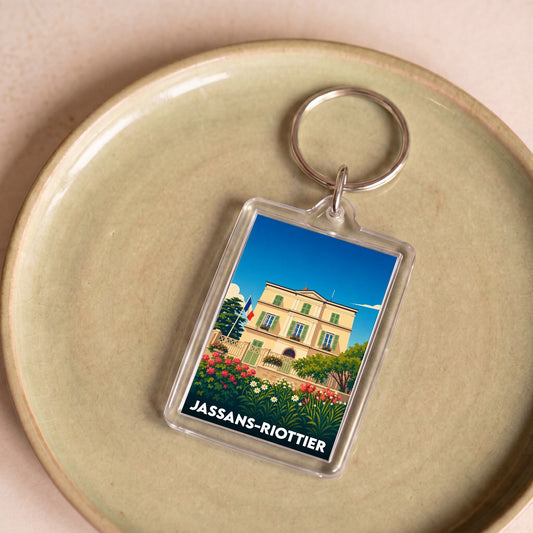 Porte-clés souvenir de la ville de Jassans-Riottier avec une illustration stylisée.