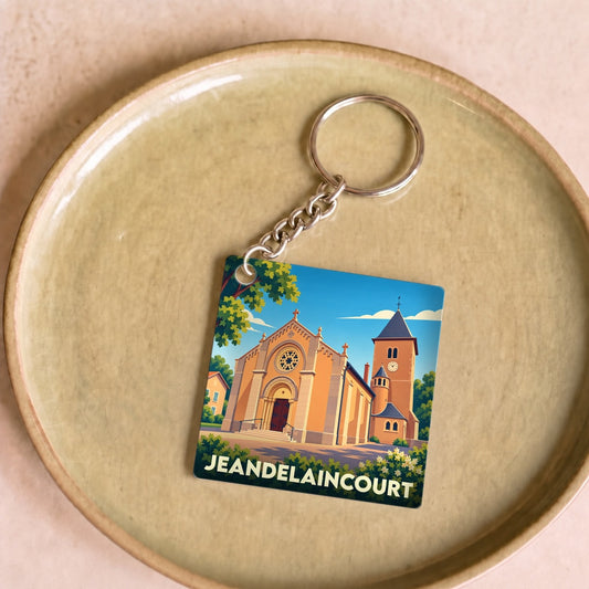 Porte-clés souvenir de la ville de Jeandelaincourt avec une illustration stylisée de son église.