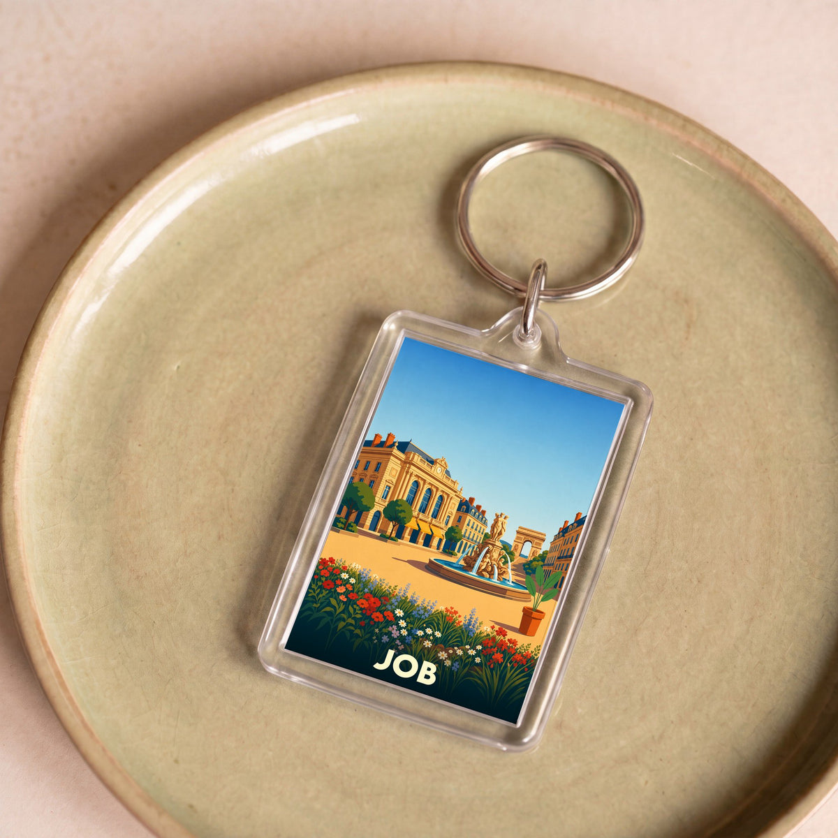 Porte-clés souvenir de la ville de Job avec une illustration stylisée.
