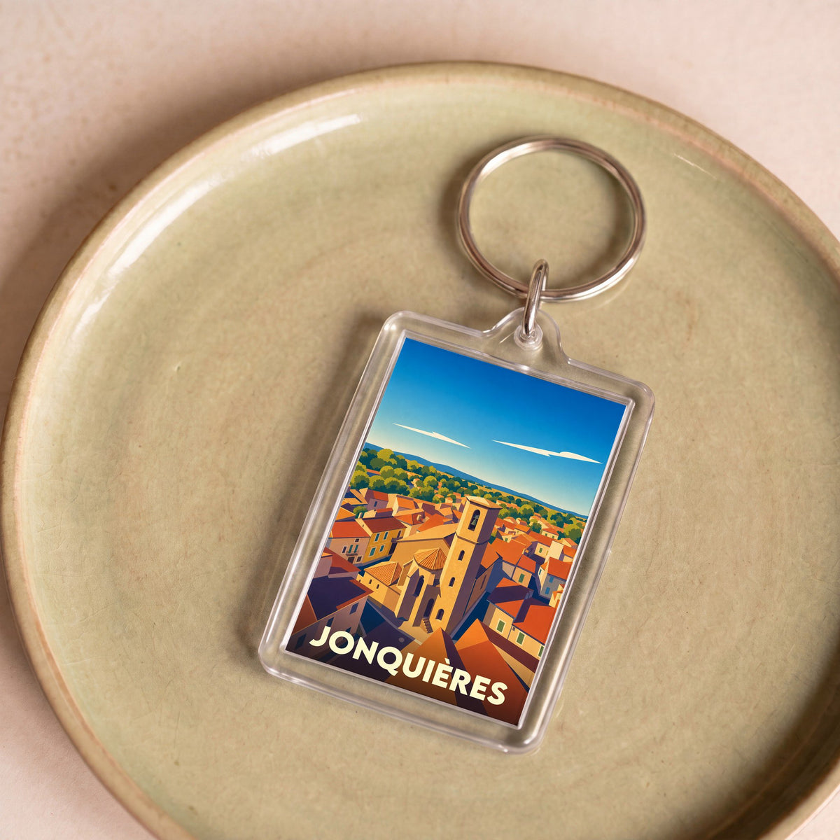 Porte-clés souvenir de la ville de Jonquières avec une illustration stylisée.