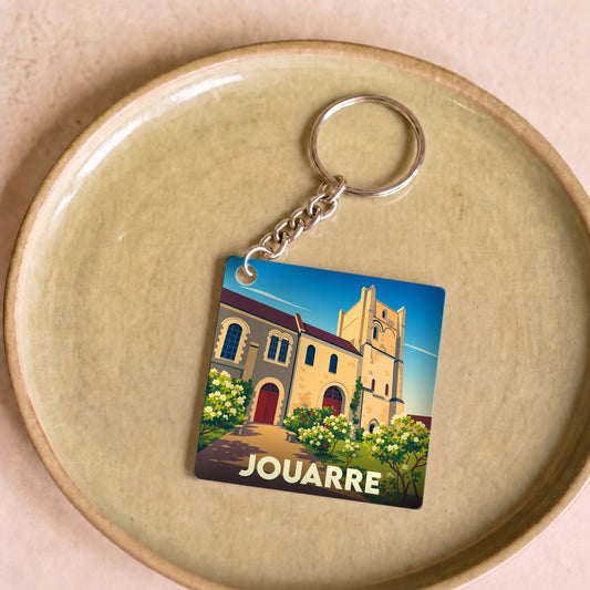 Porte-clés souvenir de la ville de Jouarre avec une illustration stylisée de son patrimoine architectural.