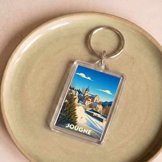 Porte-clés souvenir de la ville de Jougne avec une illustration hivernale stylisée.