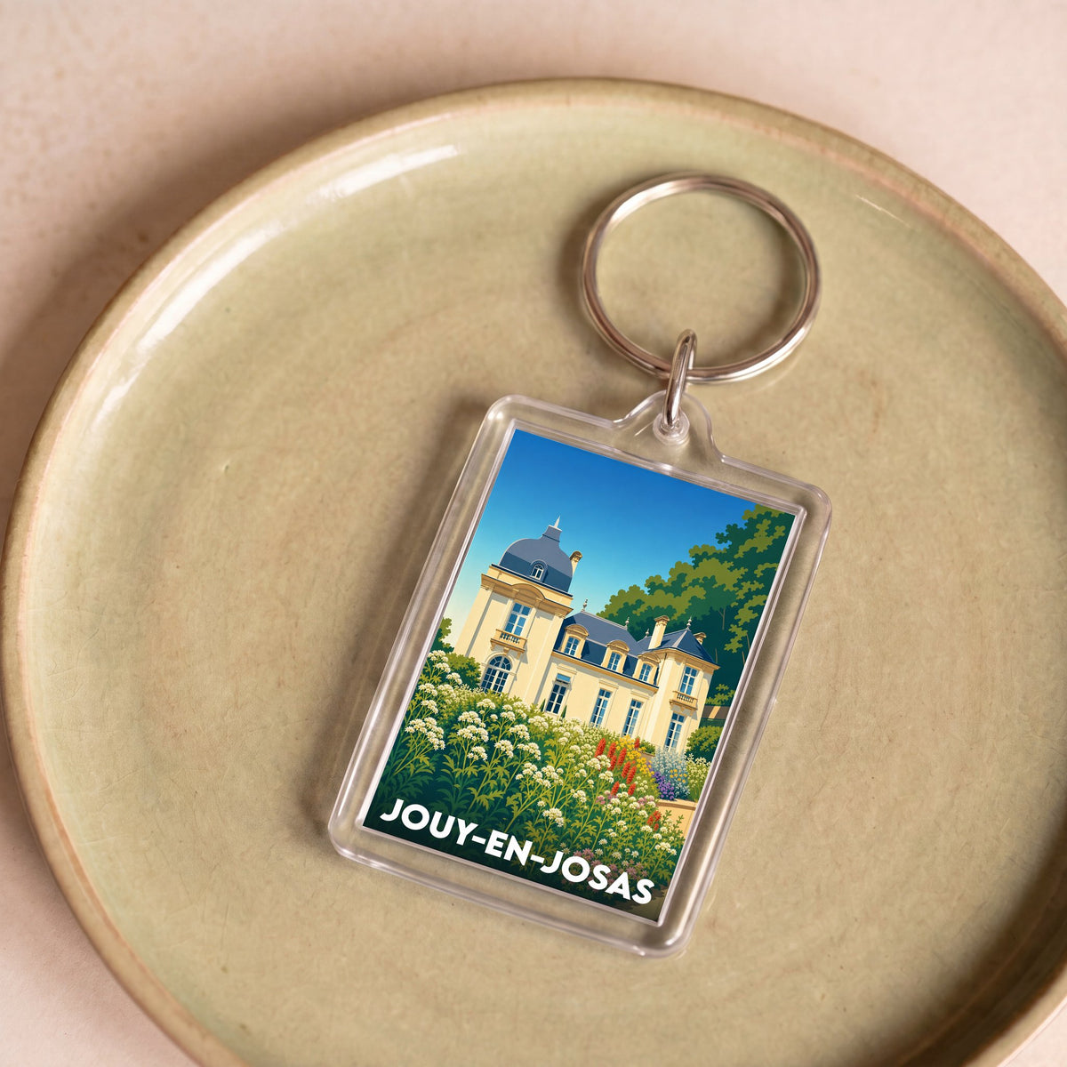 Porte-clés souvenir de la ville de Jouy-en-Josas avec une illustration stylisée de son patrimoine.