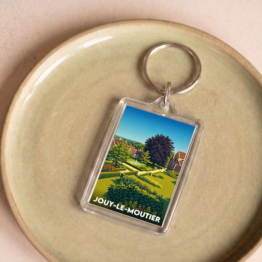 Porte-clés souvenir de la ville de Jouy-le-Moutier avec une illustration stylisée.