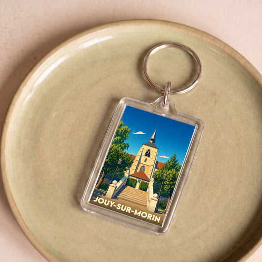 Porte-clés souvenir de la ville de Jouy-sur-Morin avec une illustration stylisée de son église.