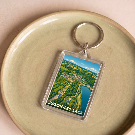 Porte-clés souvenir de la ville de Jugon-les-Lacs avec une illustration stylisée.
