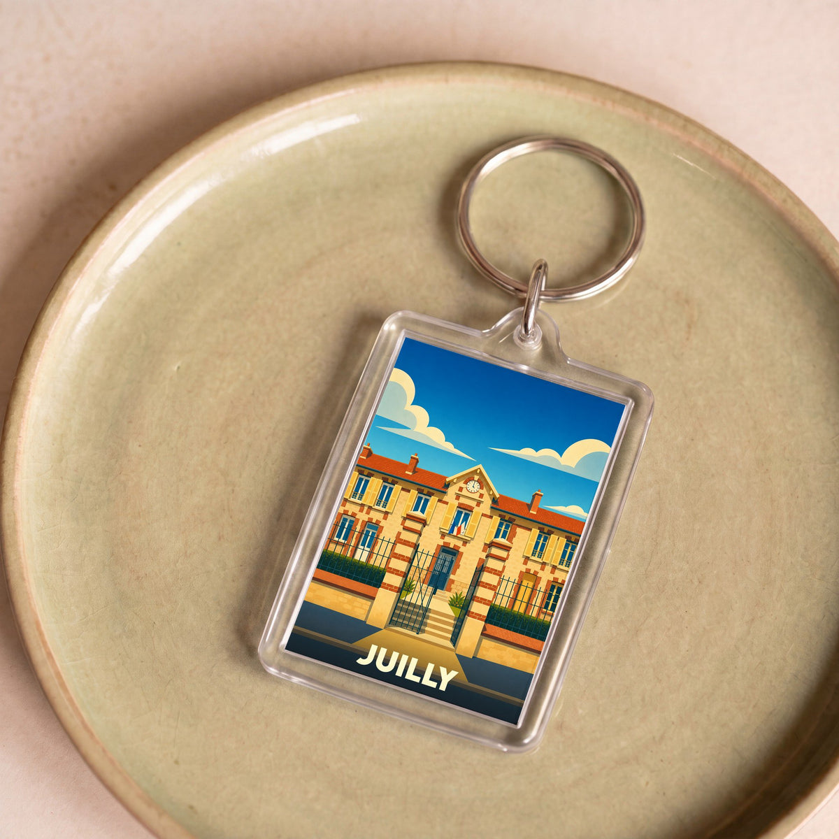 Porte-clés souvenir de la ville de Juilly avec une illustration stylisée de sa mairie.