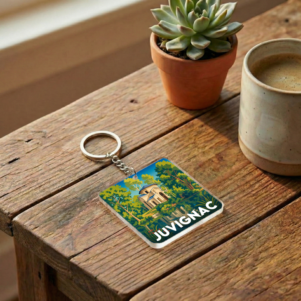 Porte-clés souvenir de la ville de Juvignac avec une illustration stylisée.