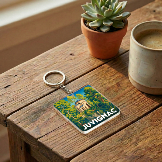 Porte-clés souvenir de la ville de Juvignac avec une illustration stylisée.