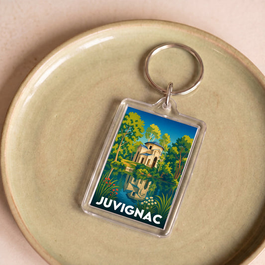 Porte-clés souvenir de la ville de Juvignac avec une illustration stylisée.