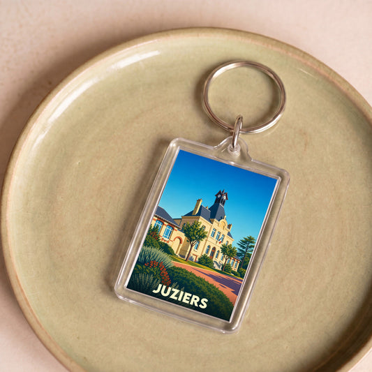 Porte-clés souvenir de la ville de Juziers avec une illustration stylisée de son hôtel de ville.