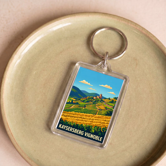 Porte-clés souvenir de la ville de Kaysersberg Vignoble avec une illustration stylisée de son paysage.