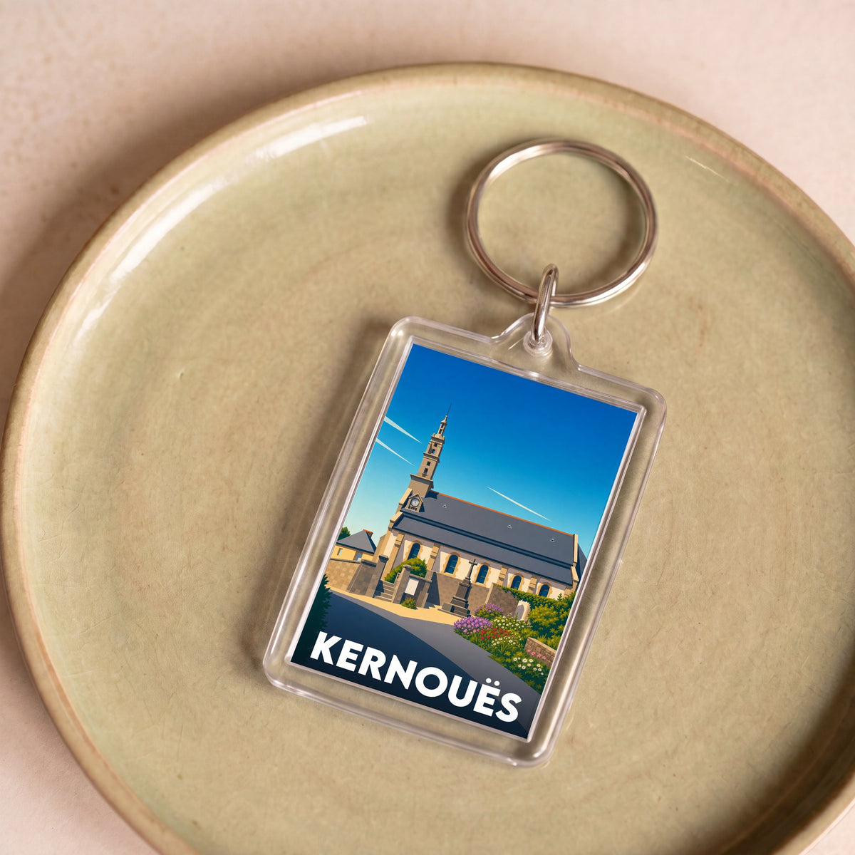 Porte-clés souvenir de la ville de Kernouës avec une illustration stylisée.