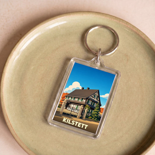 Porte-clés souvenir de la ville de Kilstett avec une illustration stylisée d'une maison à colombages.
