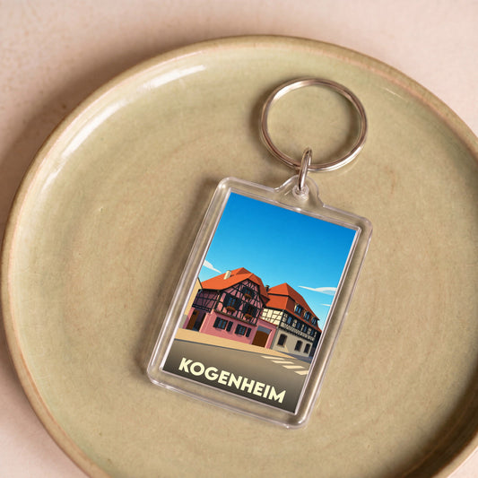 Porte-clés souvenir de la ville de Kogenheim avec une illustration stylisée de maisons à colombages.