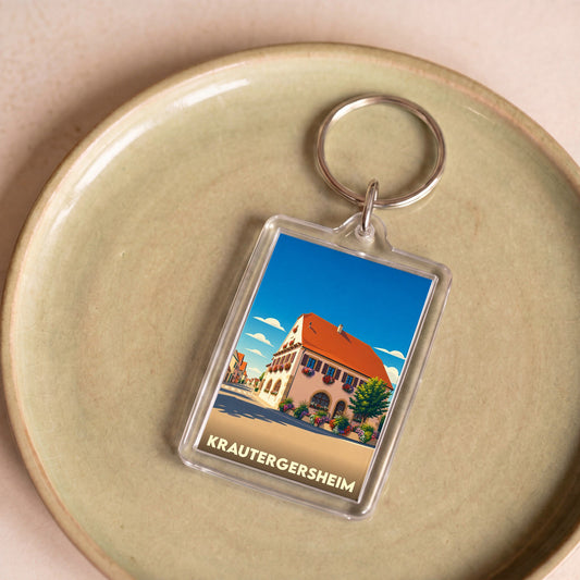Porte-clés souvenir de la ville de Krautergersheim avec une illustration stylisée d'une maison alsacienne fleurie.