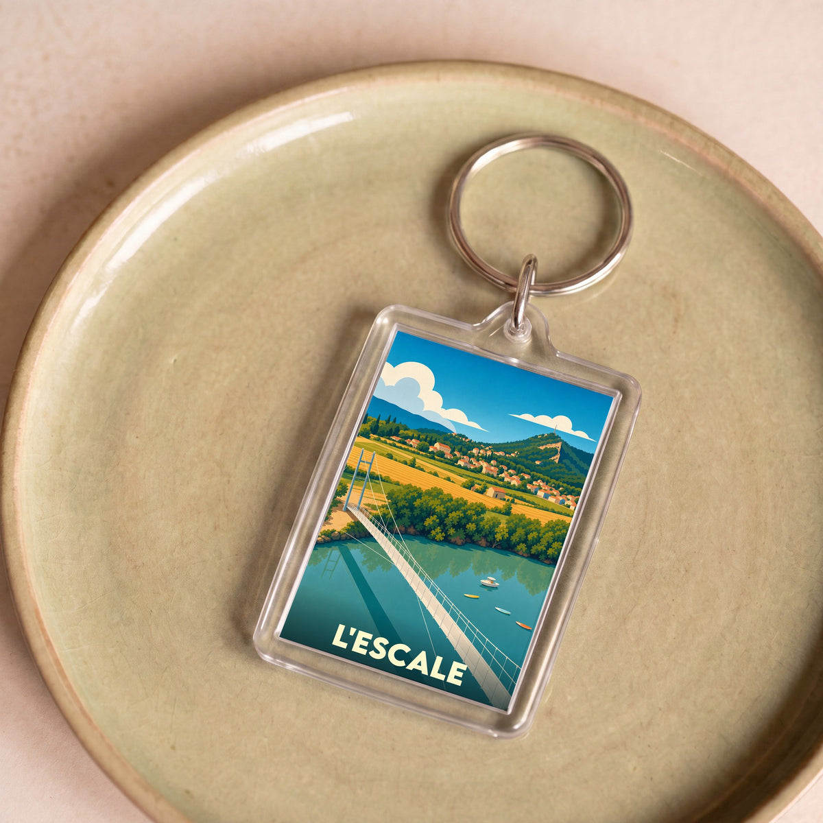 Porte-clés souvenir de la ville de L'Escale avec une illustration stylisée de son pont et de ses paysages.