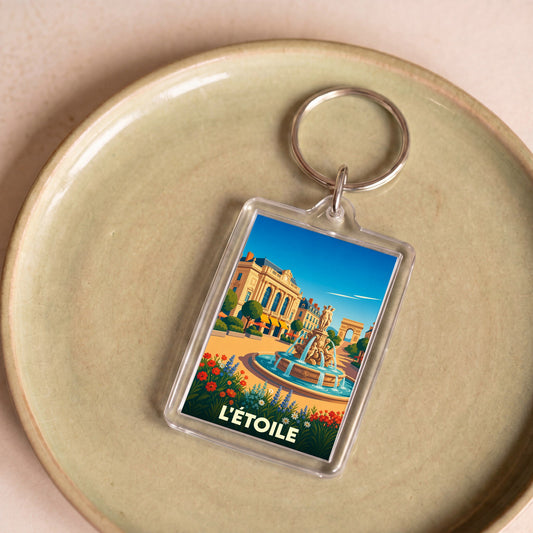 Porte-clés souvenir de la ville de L'Étoile avec une illustration colorée et stylisée.