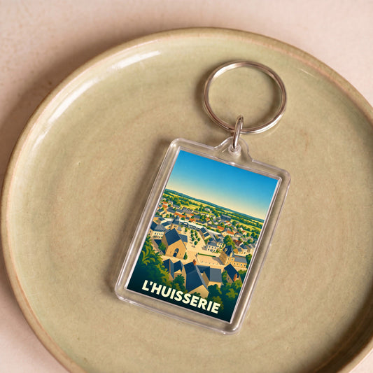 Porte-clés souvenir de la ville de L'Huisserie avec une illustration stylisée.