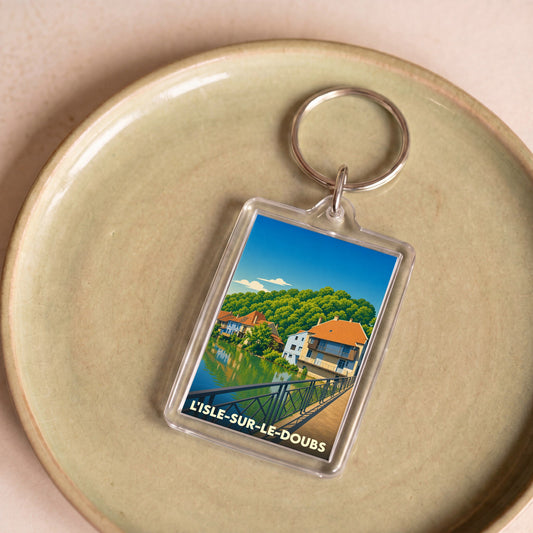 Porte-clés souvenir de la ville de L'Isle-sur-le-Doubs avec une illustration stylisée.
