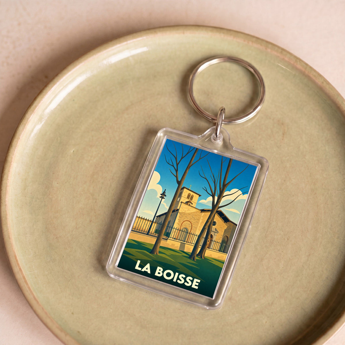 Porte-clés souvenir de la ville de La Boisse avec une illustration stylisée.