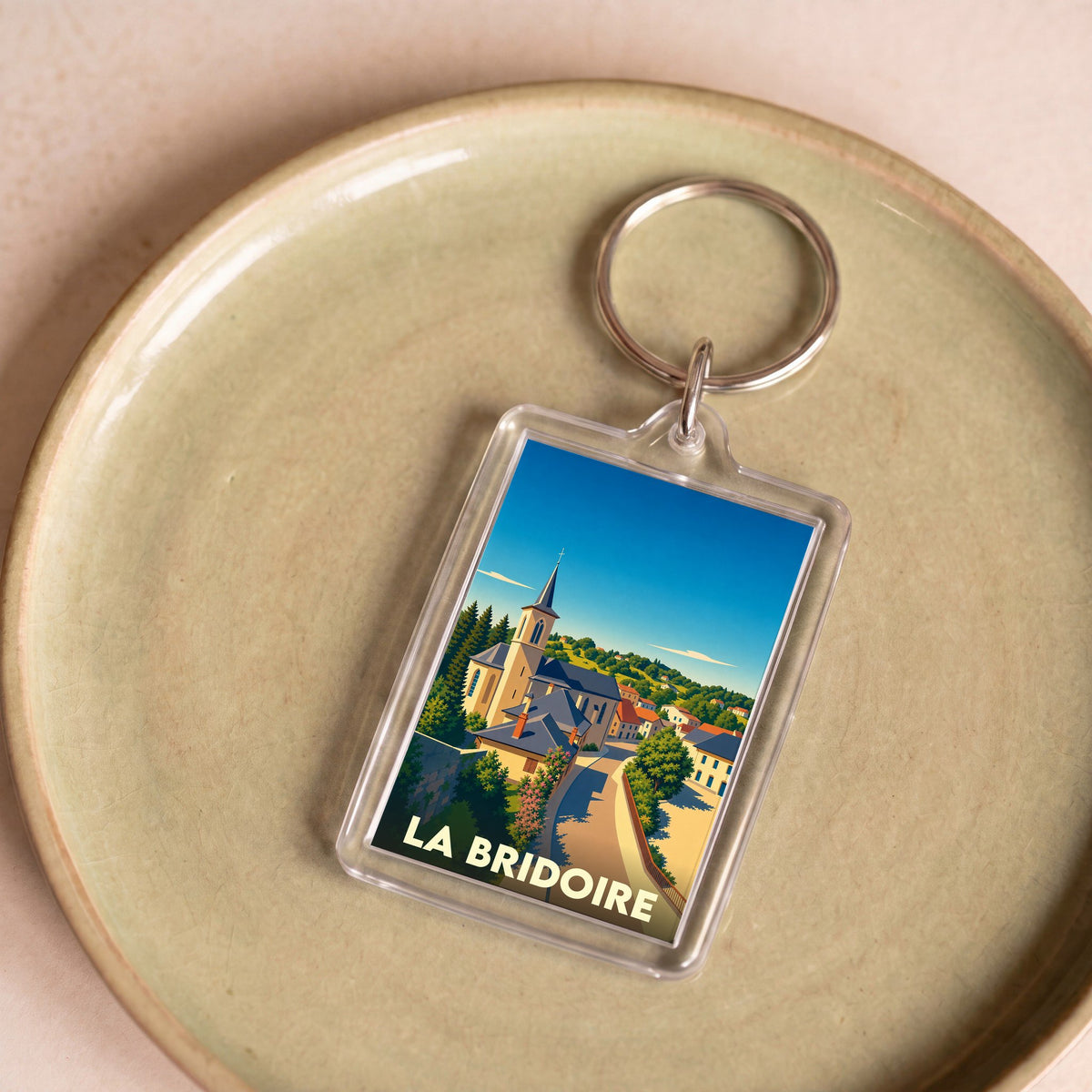Porte-clés souvenir de la ville de La Bridoire avec une illustration stylisée.
