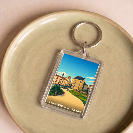 Porte-clés souvenir de la ville de La Caillère-Saint-Hilaire avec une illustration stylisée.