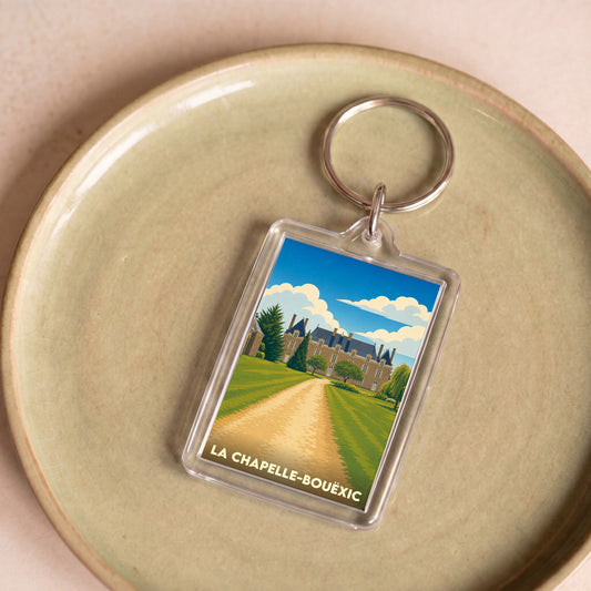 Porte-clés souvenir de la ville de La Chapelle-Bouëxic avec une illustration stylisée de son château.