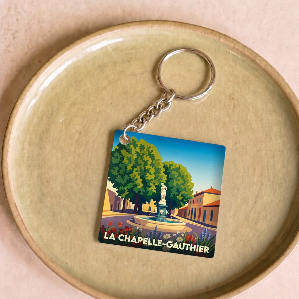 Porte-clés souvenir de la ville de La Chapelle-Gauthier avec une illustration stylisée.