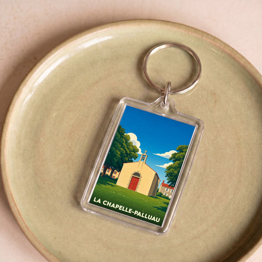 Porte-clés souvenir de la ville de La Chapelle-Palluau avec une illustration stylisée d'une petite chapelle sous un ciel bleu.
