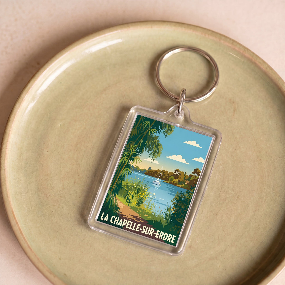 Porte-clés souvenir de la ville de La Chapelle-sur-Erdre avec une illustration stylisée.