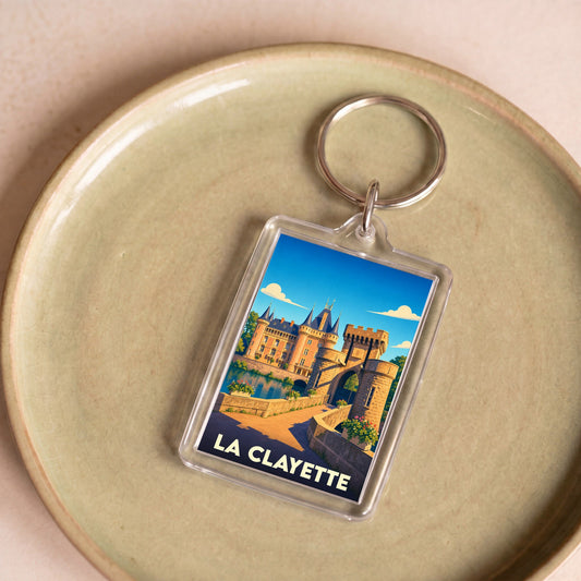Porte-clés souvenir de la ville de La Clayette avec une illustration stylisée de son château.