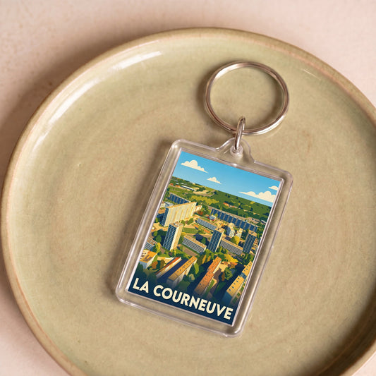 Porte-clés souvenir de la ville de La Courneuve avec une illustration stylisée.