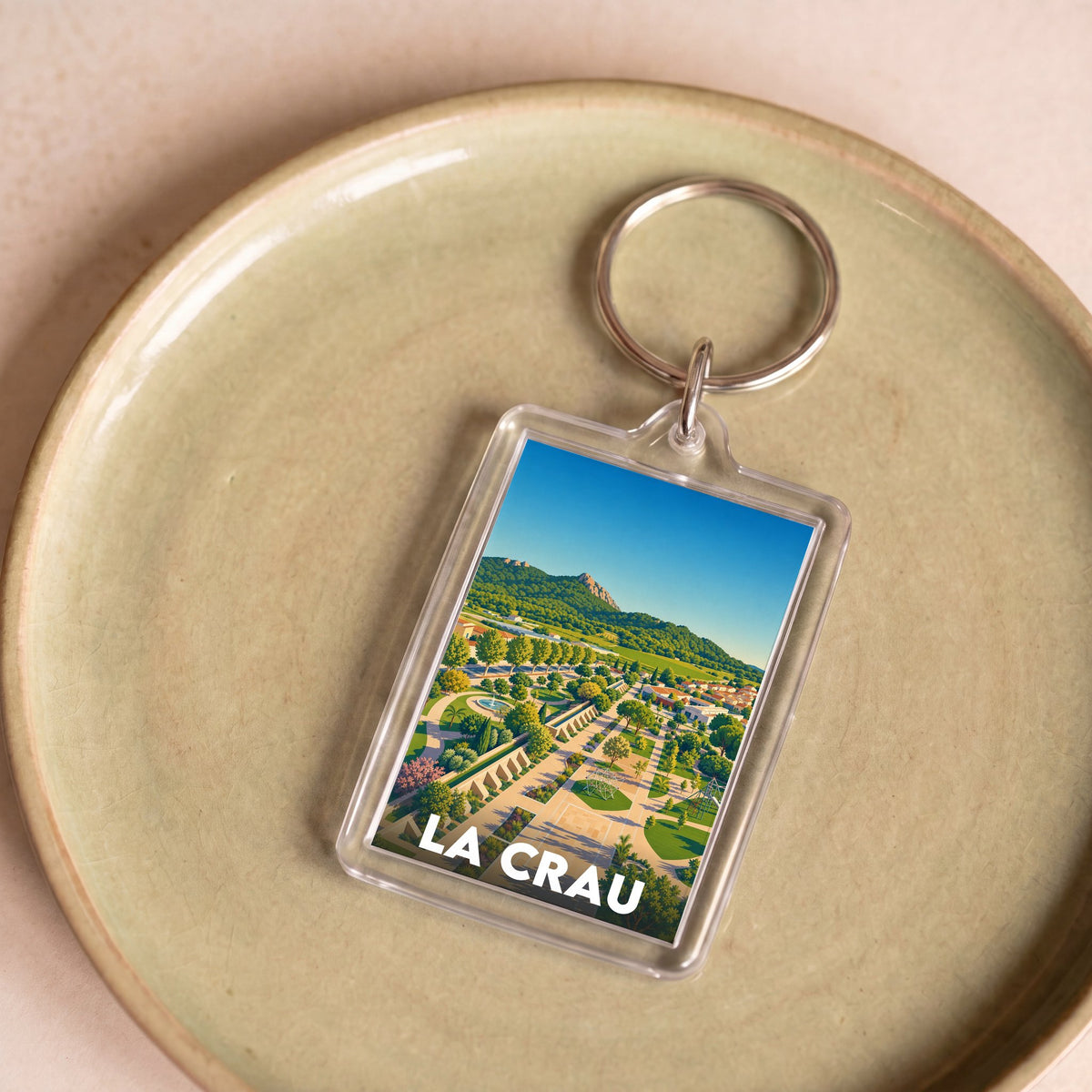 Porte-clés souvenir de la ville de La Crau avec une illustration stylisée.