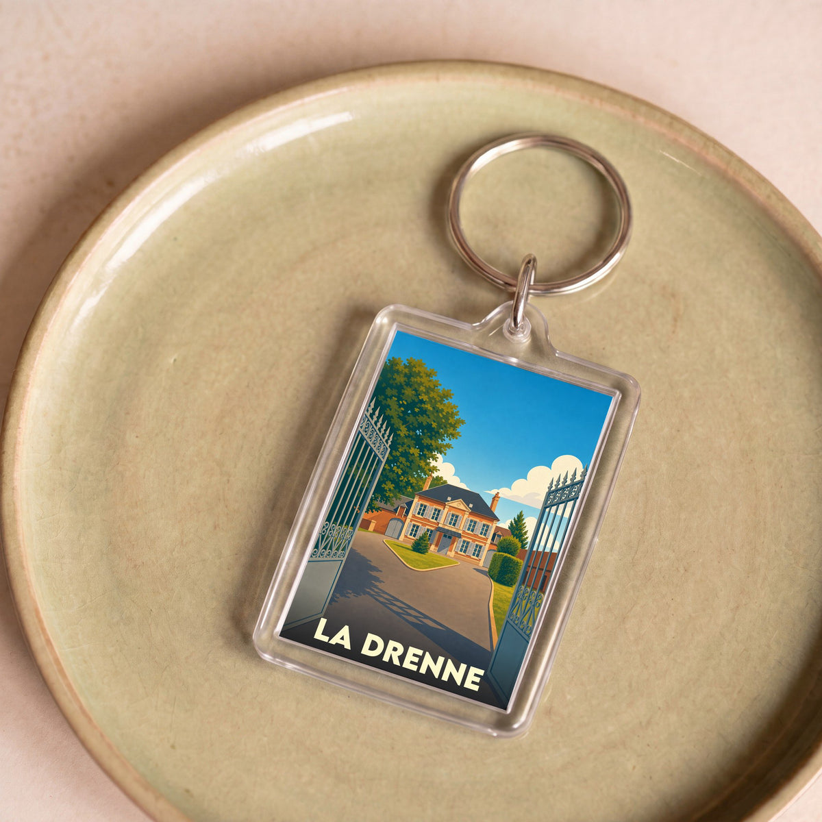 Porte-clés souvenir de la ville de La Drenne avec une illustration stylisée.