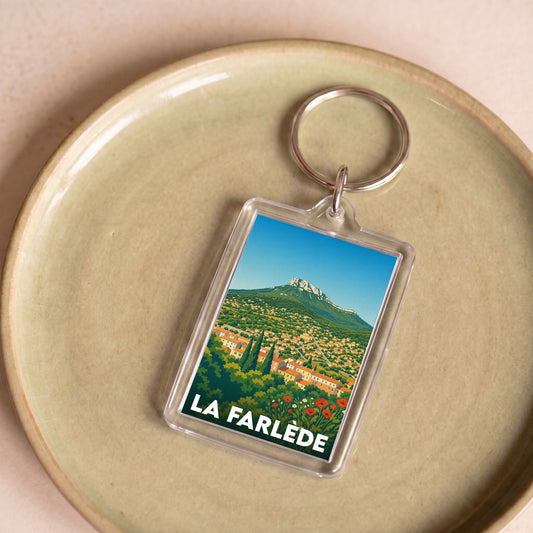 Porte-clés souvenir de la ville de La Farlède avec une illustration stylisée du paysage.