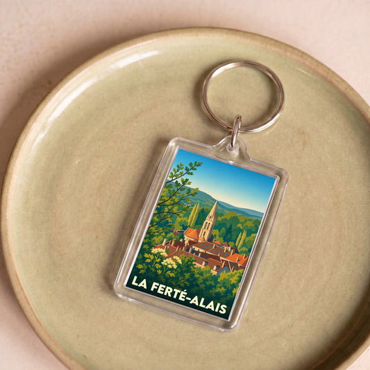 Porte-clés souvenir de la ville de La Ferté-Alais avec une illustration stylisée.