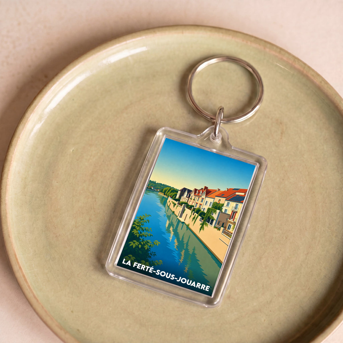 Porte-clés souvenir de la ville de La Ferté-sous-Jouarre avec une illustration stylisée.