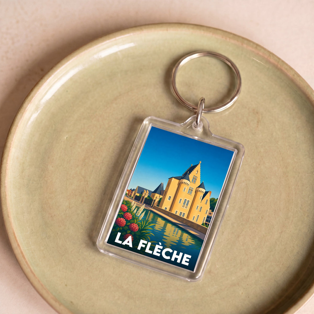 Porte-clés souvenir de la ville de La Flèche avec une illustration stylisée.