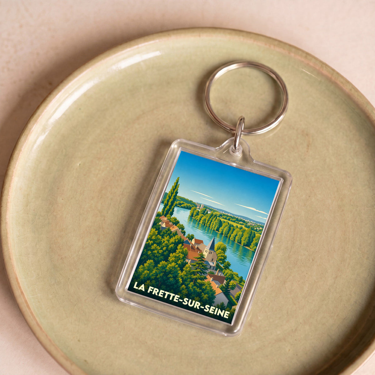 Porte-clés souvenir de la ville de La Frette-sur-Seine avec une illustration stylisée des bords de Seine.