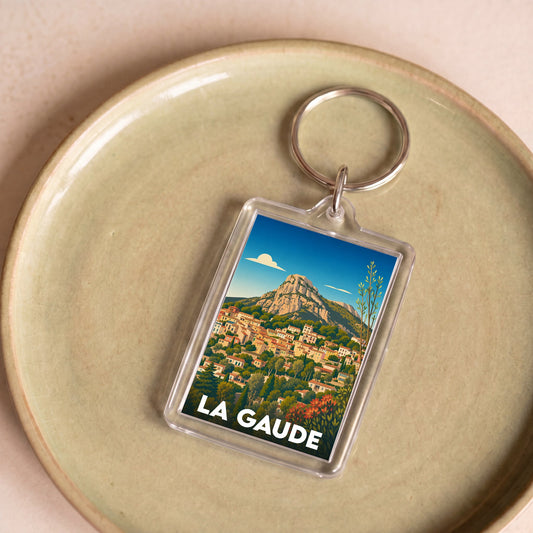 Porte-clés souvenir de la ville de La Gaude avec une illustration colorée et stylisée du village.