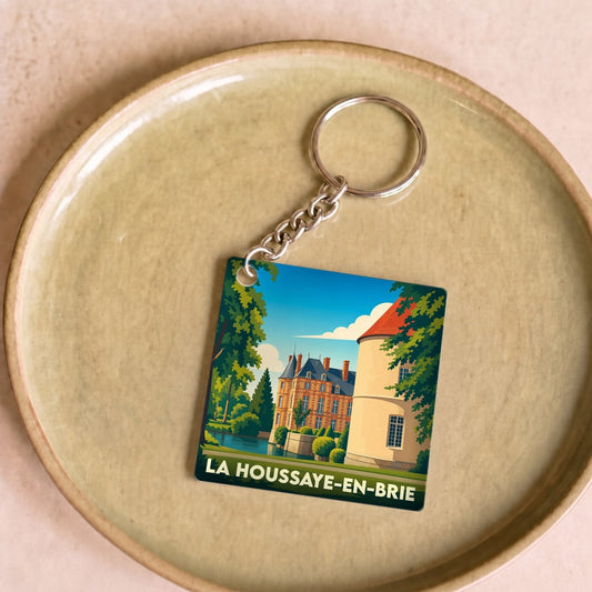 Porte-clés souvenir de la ville de La Houssaye-en-Brie avec une illustration stylisée de son château.