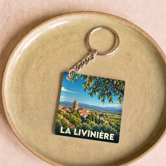 Porte-clés souvenir de la ville de La Livinière avec une illustration stylisée.