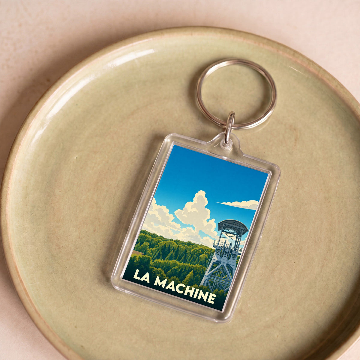 Porte-clés souvenir de la ville de La Machine avec une illustration stylisée d'un chevalement de mine.