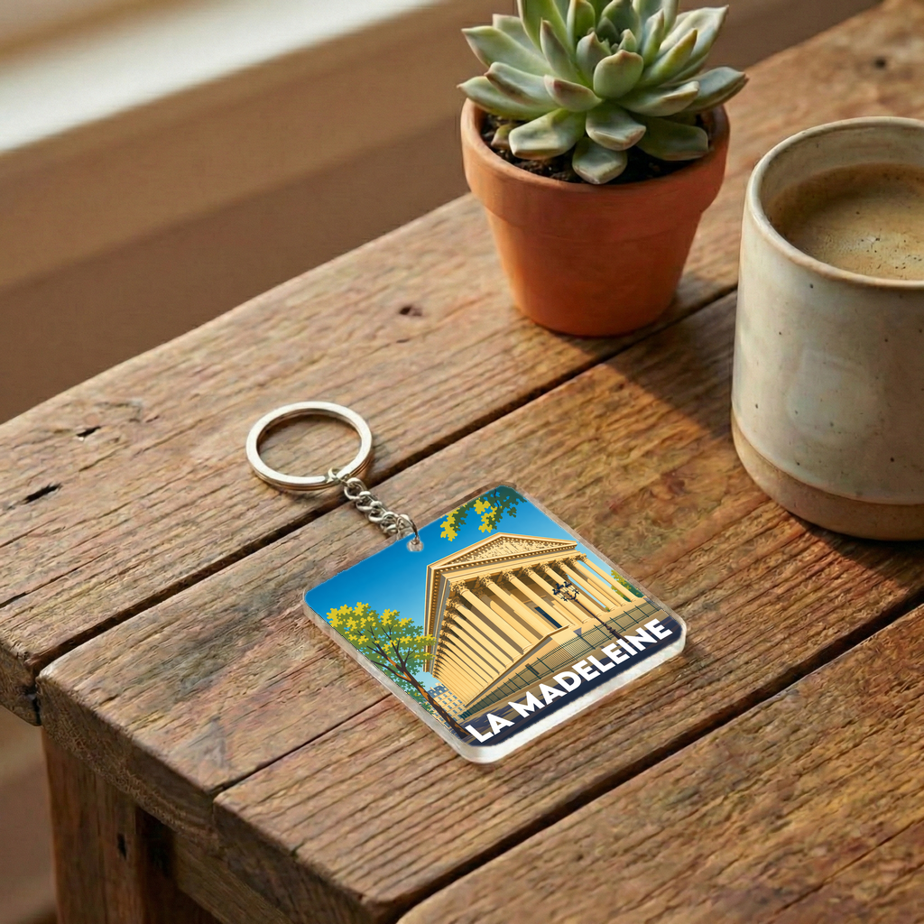 Porte-clés souvenir de la ville de La Madeleine avec une illustration stylisée.