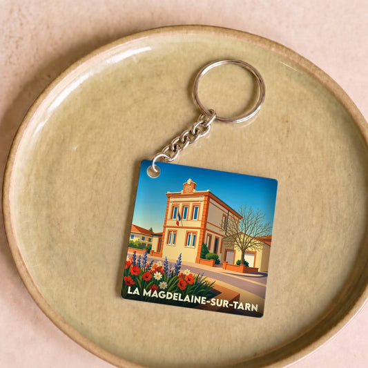 Porte-clés souvenir de la ville de La Magdelaine-sur-Tarn avec une illustration stylisée.