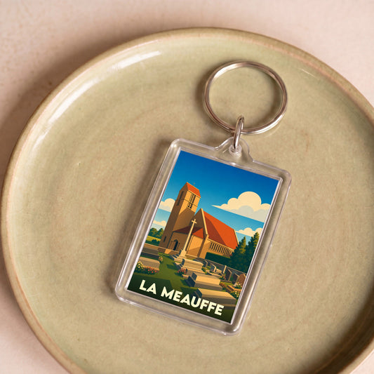 Porte-clés souvenir de la ville de La Meauffe avec une illustration stylisée de son église.