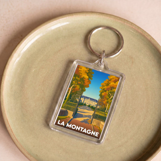 Porte-clés souvenir de la ville de La Montagne avec une illustration stylisée d'un domaine arboré.