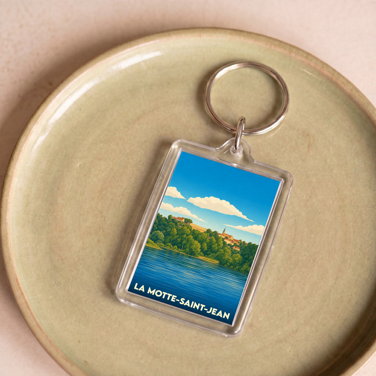 Porte-clés souvenir de la ville de La Motte-Saint-Jean avec une illustration stylisée.
